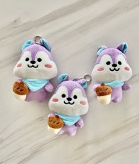 three stuffed animals are sitting on a marble surface