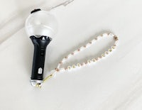 a light bulb with a necklace attached to it